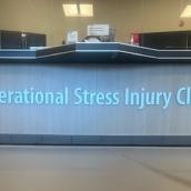A desk with the words Operational Stress Injury Clinic lit up in blue.