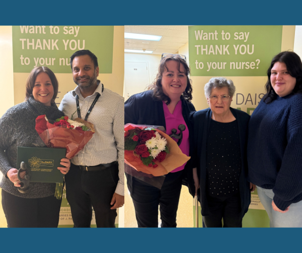 Five people are standing to give and receive an award; the winners are holding a bouquet of flowers.