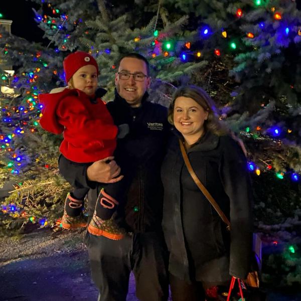 Ryan, Chelsea and Hailey Parker in front of the holiday tree. 